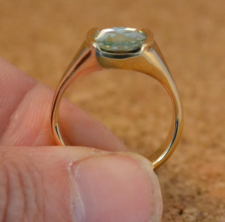 Side view of 14k yellow gold and green stone
